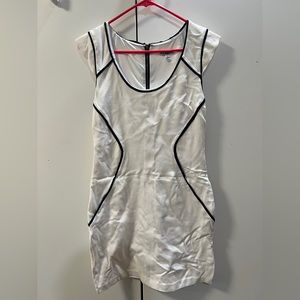 White dress with black details.